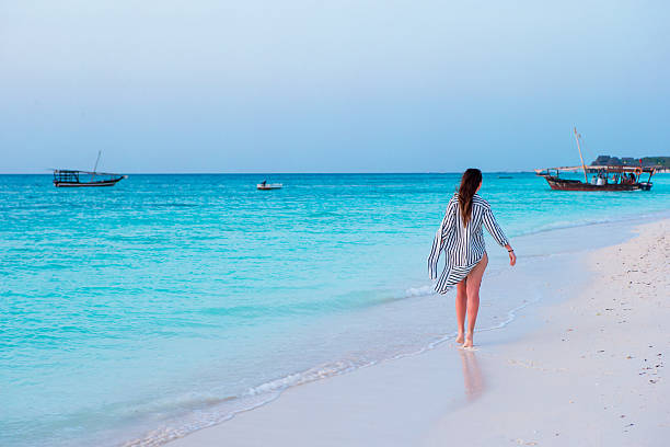 Young beautiful woman relaxing at white sand tropical beach